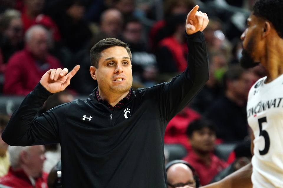 Cincinnati Bearcats head coach Wes Miller instructs the team in the first half of an NCAA men's college basketball game against the Tulsa Golden Hurricane, Thursday, Jan. 20, 2022, at Fifth Third Arena in Cincinnati.