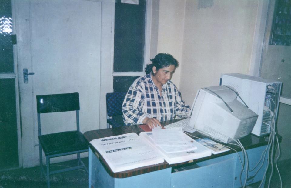 Marzia Babakarkhail works at her desk in Afghanistan in the 1990s.