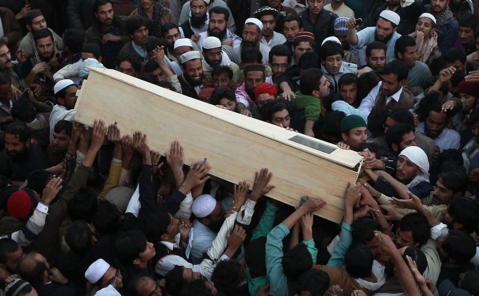 Sunni Muslims carry the casket of a fellow Sunni who was killed in Friday's sectarian clashes during a Muharram procession, at Laiquat Bagh in Rawalpindi
