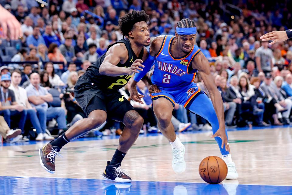 Oklahoma City guard Shai Gilgeous-Alexander (2) works past Utah guard Collin Sexton (2) in the fourth quarter during an NBA basketball game between the Oklahoma City Thunder and the Utah Jazz at the Paycom Center in Oklahoma City, on Wednesday, March 20, 2024.