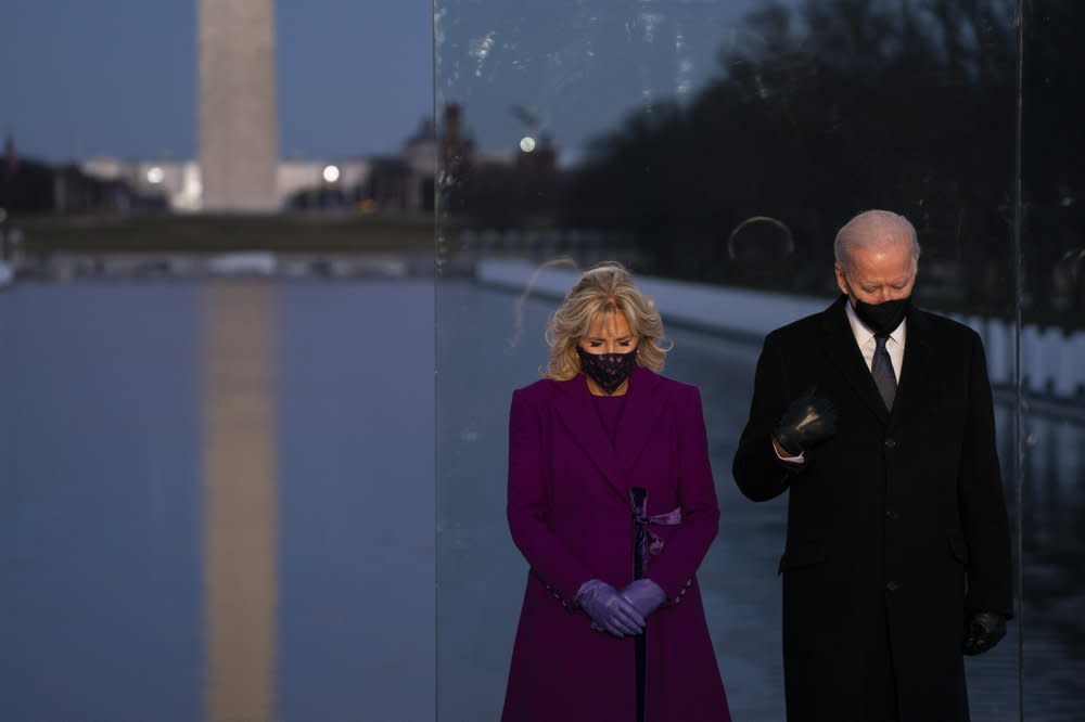 President-elect Joe Biden and his wife Jill Biden participate in a COVID-19 memorial event at the Lincoln Memorial Reflecting Pool, Tuesday, Jan. 19, 2021, in Washington. (AP Photo/Evan Vucci)