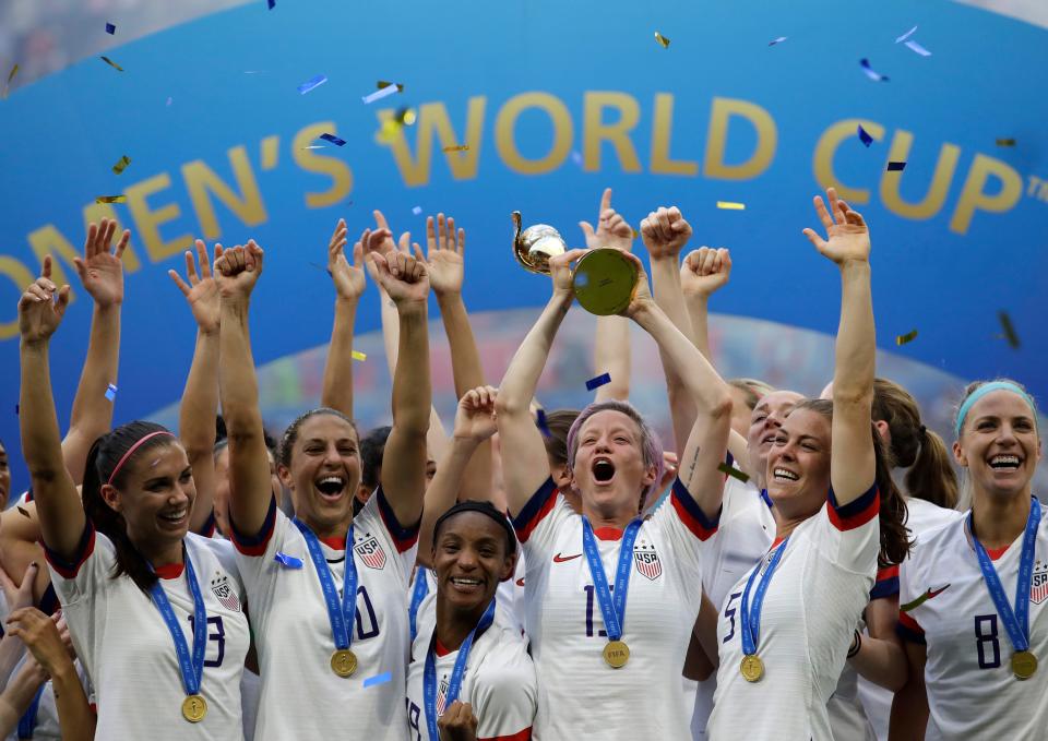 United States' Megan Rapinoe lifts up the trophy after winning the Women's World Cup final soccer match between US and The Netherlands at the Stade de Lyon in Decines, outside Lyon, France, in July 7, 2019. The U.S. Soccer Federation reached milestone agreements to pay its men's and women's teams equally, making the American national governing body the first in the sport to promise both sexes matching money.