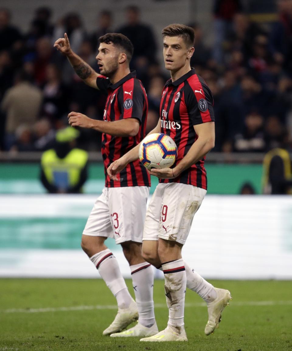 AC Milan's Patrick Cutrone, left, and Krzysztof Piatek react during the Italian Cup, second leg semifinal soccer match between AC Milan and Lazio, at the San Siro stadium, in Milan, Italy, Wednesday, April 24, 2019. (AP Photo/Luca Bruno)