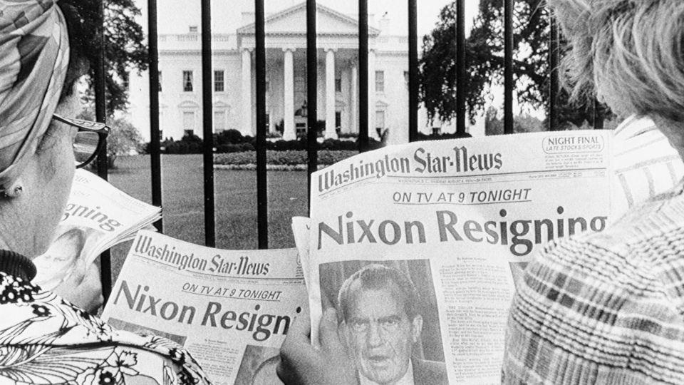 Tourists outside the White House read newspaper headlines about President Nixon's impending resignation on August 8, 1974. - Bettmann/Getty Images