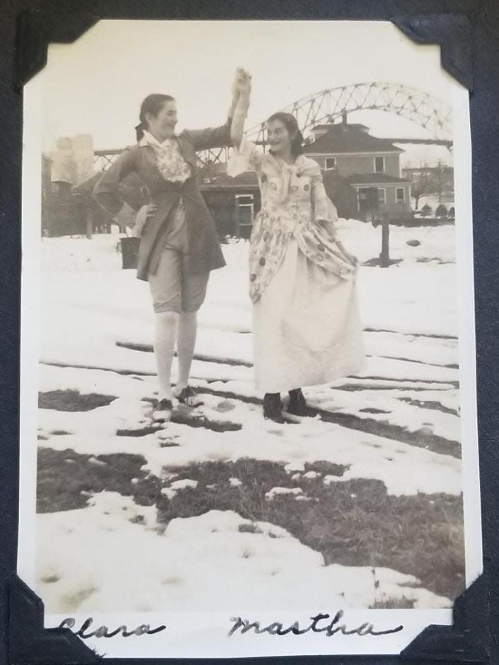 In a 1940 family photo owned by Bourne resident Jim Poore, his grandmother (left), Clara Cecchi, holds hands with a friend at the home of his great-grandparents on Sandwich Road in Bourne. The Sagamore Bridge, then about five years old, is in the background.