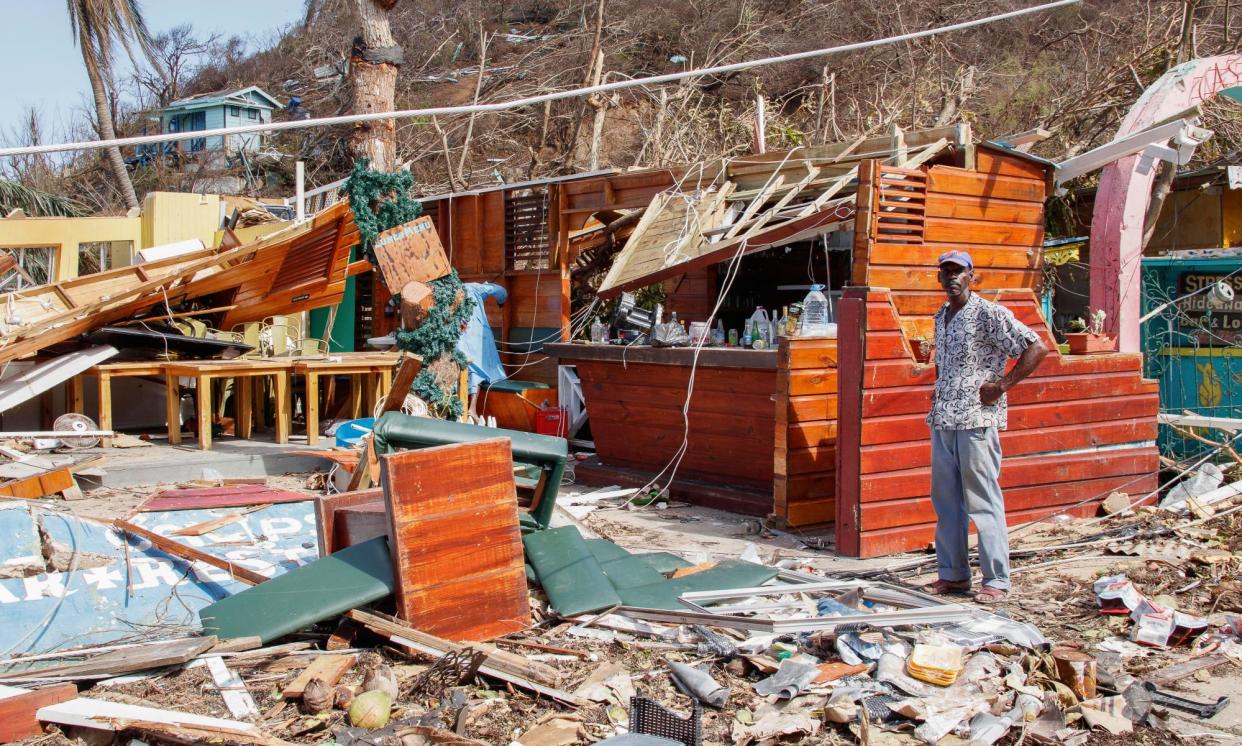 <span>A man stands next to a business destroyed by Hurricane Beryl in Clifton, Union Island, St Vincent and the Grenadines.</span><span>Photograph: Lucanus Ollivierre/AP</span>