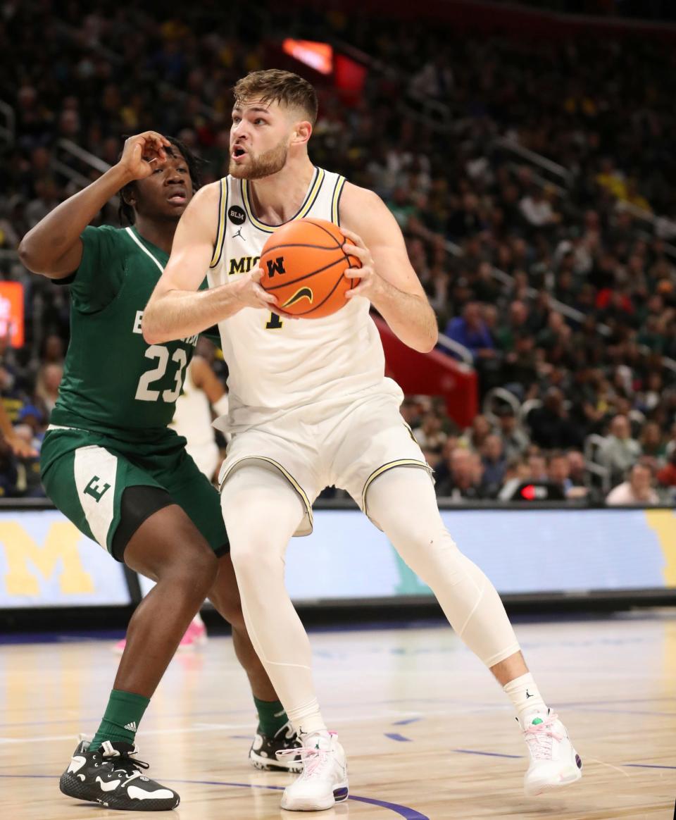 Michigan center Hunter Dickinson takes on Eastern Michigan forward Legend Geeter in the second half of UM's 88-83 win at Little Caesars Arena on Friday, November 9, 2022.