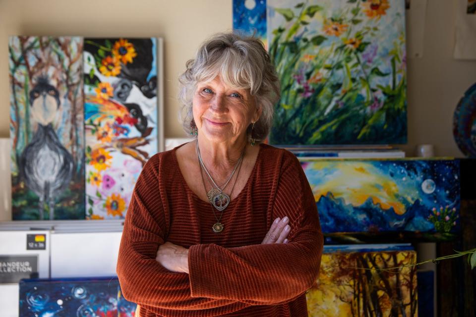 Local artist Vicki Crouse Henley poses for a portrait next to her paintings on Tuesday, Jan. 16, 2024, at her home. The LCIFF board announced that she will be this year’s poster artist for the Las Cruces International Film Festival.