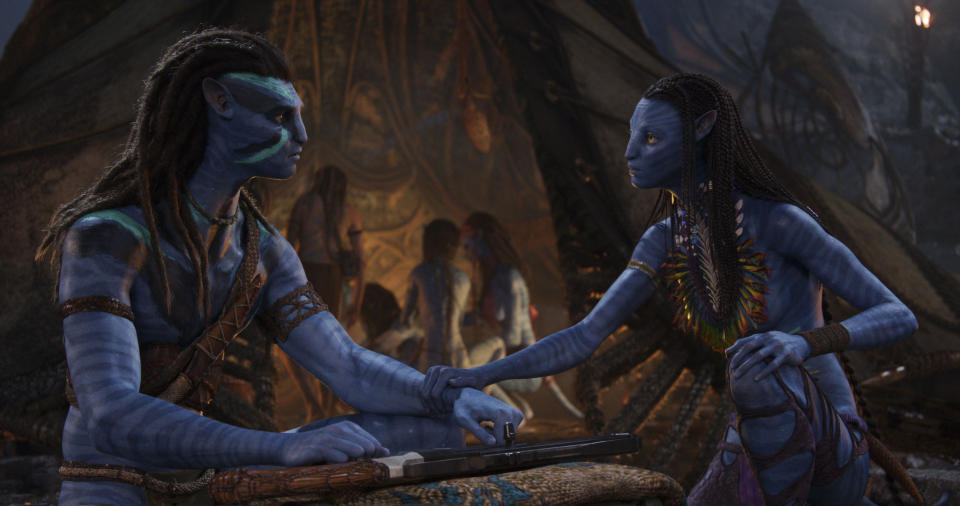 This image released by 20th Century Studios shows Jake Sully, voiced by Sam Worthington, left, and Neytiri, voiced by Zoe Saldana in a scene from "Avatar: The Way of Water." (20th Century Studios via AP)