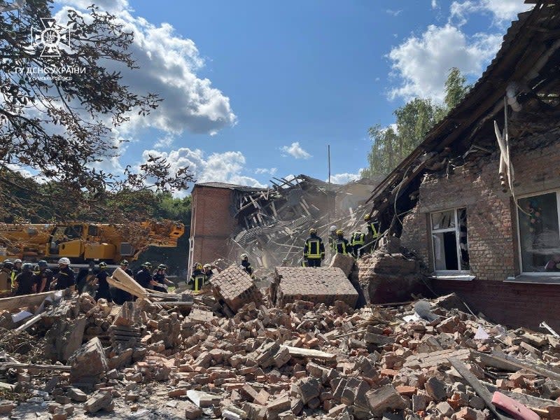 Rescuers clearing debris of a destroyed school following a Russian strike, in the town of Romny, (Ukrainian State Emergency Servic)