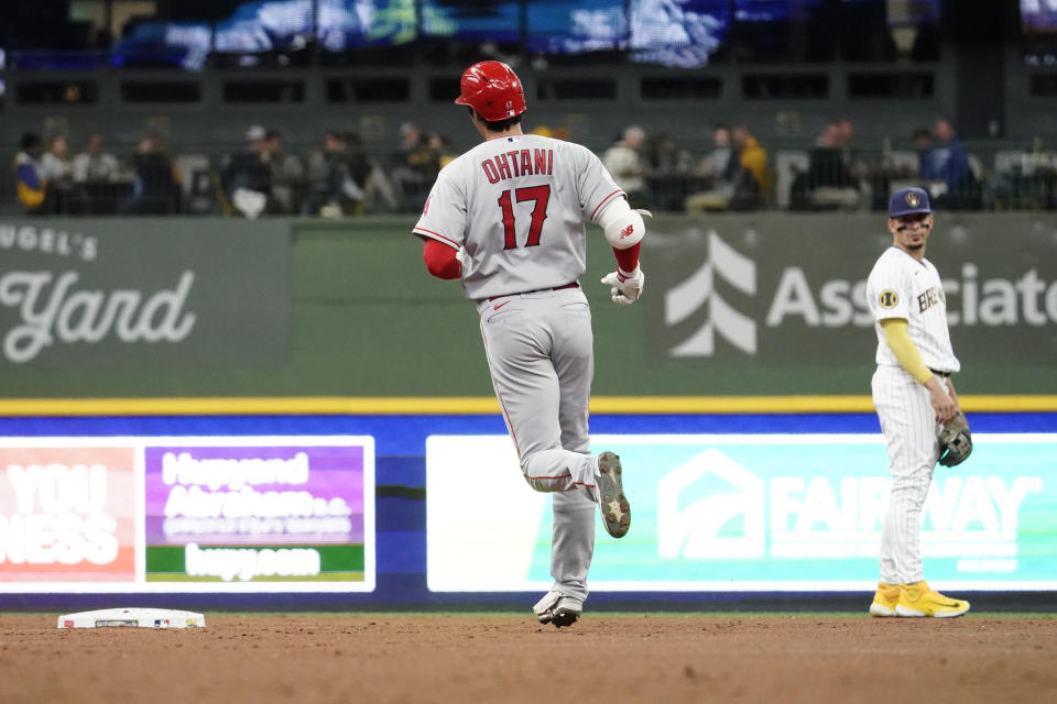 Los Angeles Angels' Shohei Ohtani (17) rounds the bases in front of Milwaukee Brewers' Willy Adames during the third inning of a baseball game, Sunday, April 30, 2023, in Milwaukee. (AP Photo/Aaron Gash)