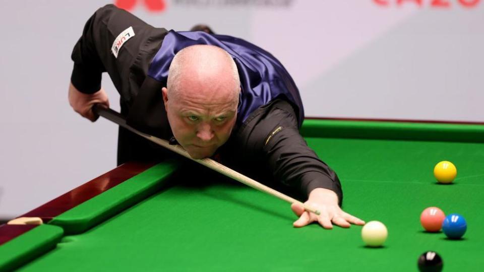 John Higgins taking a shot