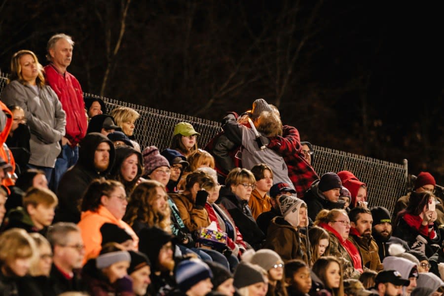 People embrace during a community prayer vigil, Tuesday, Nov. 14, 2023, at the Tuscarawas Valley Schools football stadium in Zoarville, Ohio. A charter bus filled with high school students was rear-ended by a semitruck on an Ohio highway earlier in the day, leaving several people dead and multiple others injured. (Andrew Dolph/Times Reporter via AP)