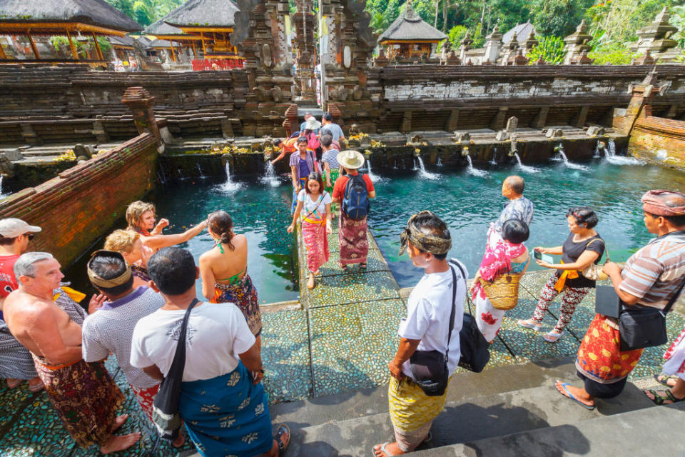 People in the purifying pool at Tirtha Empul Temple in Bali. 