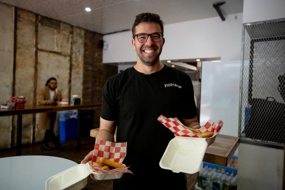 Billy McFarland and Andy King serve grilled cheese sandwiches at 7th Street Burger in the Lower East Side on April 23rd, 2023.