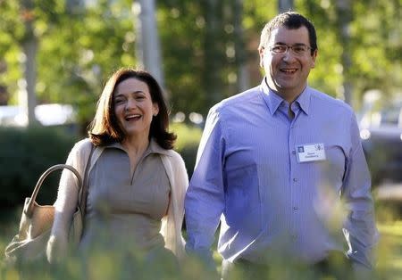 File photo of Sheryl Sandberg, Chief Operating Officer (COO) of Facebook, with her husband David Goldberg, CEO of SurveyMonkey at a media conference in Sun Valley, Idaho July 9, 2014. REUTERS/Rick Wilking