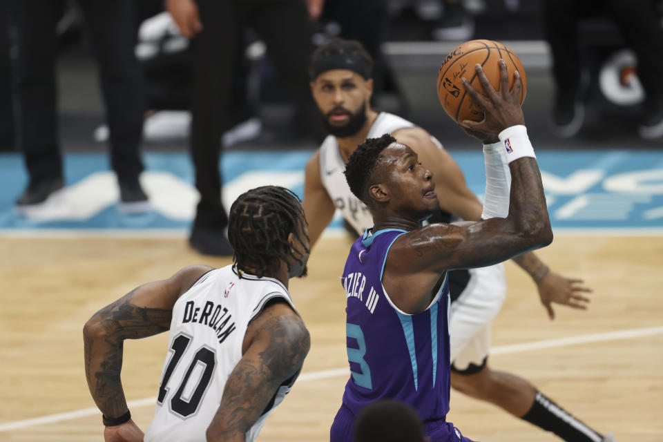 Charlotte Hornets guard Terry Rozier drives to the basket past San Antonio Spurs forward DeMar DeRozan (10) during the first half of an NBA basketball game in Charlotte, N.C., Sunday, Feb. 14, 2021. (AP Photo/Nell Redmond)
