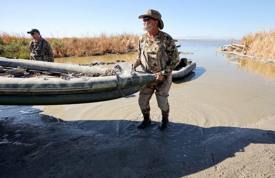 Breck Dickinson, duck hunting guide and taxidermist, loads a boat into his truck after taking clients out near Red Hill Park, in Imperial County, Calif., on Tuesday, Dec. 12, 2023. Dickinson has been hunting in the area for around 30 years and has watched the bird populations change along with changing water levels of the Salton Sea. He also said brown pelicans disappeared as fish in the lake died off, eliminating their food source. | Kristin Murphy, Deseret News