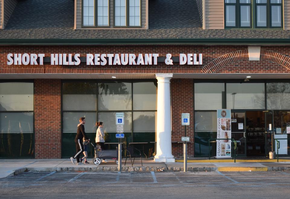 A couple on Tuesday push an infant past the now-closed Short Hills Restaurant & Deli in Cherry Hill.