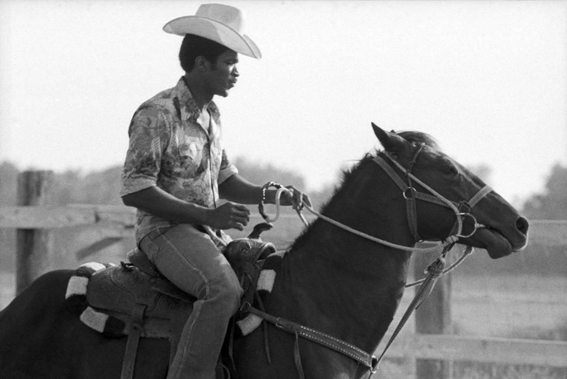 A rider on horseback practices for the rodeo and parade for the Juneteenth festival. The rodeo was held at the Circle L 5 Riding Club arena, the Stop Six Corral near Eastland Street and Loop 820 in Fort Worth, in 1977.