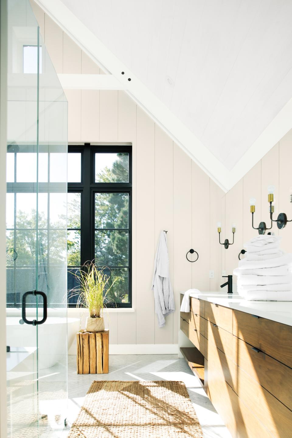 a modern bright bathroom with black windows