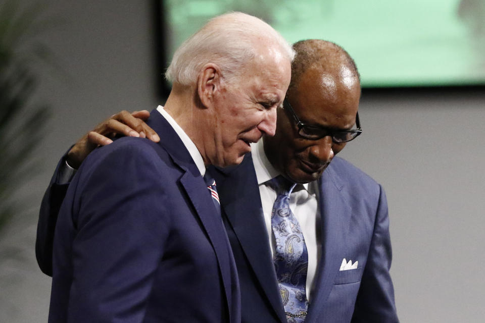 Democratic presidential candidate and former Vice President Joe Biden left, is escorted to the podium by Pastor Jerry Young at New Hope Baptist Church, Sunday, March 8, 2020, in Jackson, Miss. (AP Photo/Rogelio V. Solis)