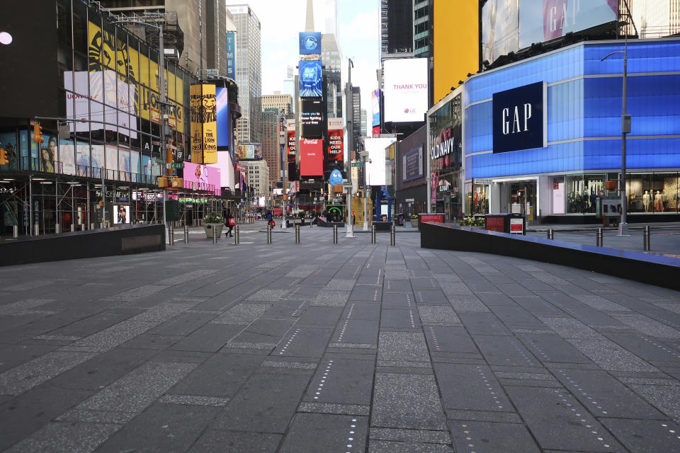 Times Square is nearly empty of pedestrians during the coronavirus pandemic in New York City on Tuesday, April 21, 2020. (AP Photo/Ted Shaffrey)