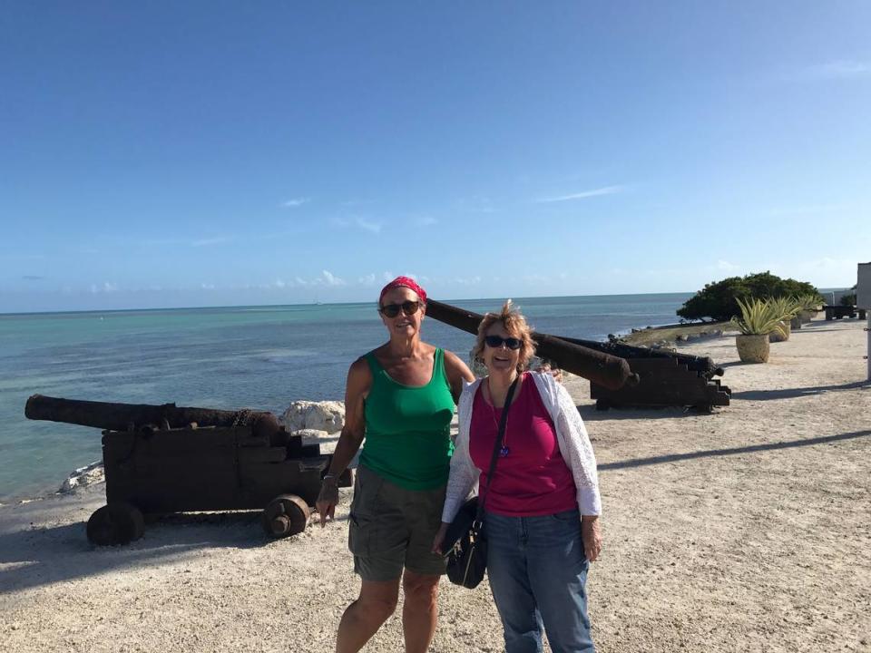 Liz Hillenbrand, of Oneida, New York, and Gretchen Hull, of Branford, Florida, pose near cannons that line the shore of Whale Harbor Marina in Islamorada, Thursday, March 12, 2020.