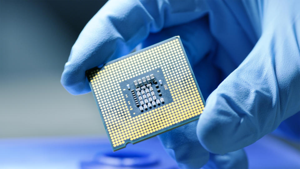 Silicon chip held by a gloved hand