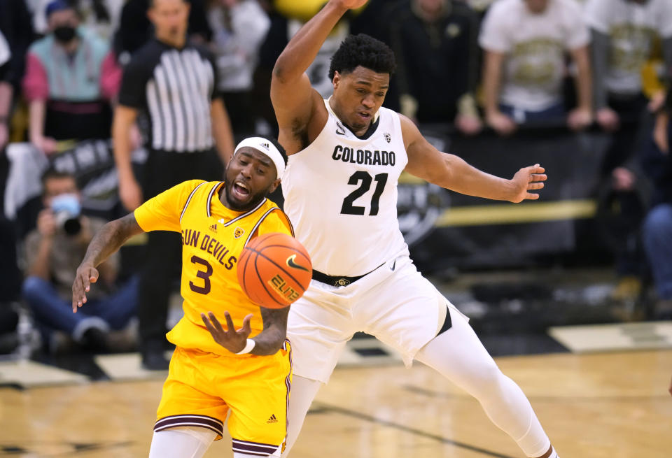 Arizona State guard Marreon Jackson, left, is fouled by Colorado forward Evan Battey while pursuing a loose ball during the first half of an NCAA college basketball game Thursday, Feb. 24, 2022, in Boulder, Colo. (AP Photo/David Zalubowski)