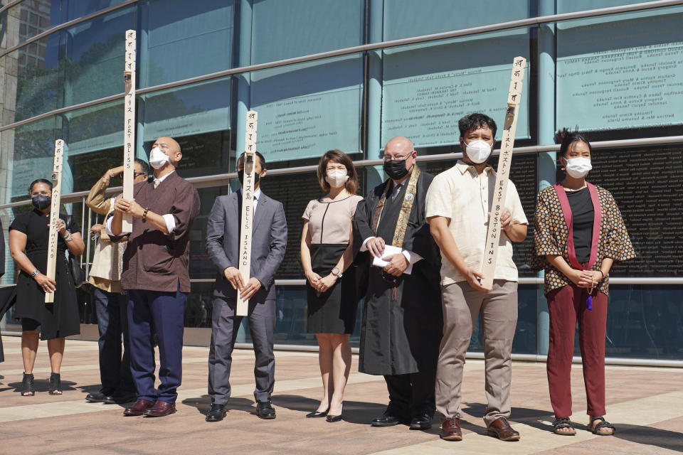 In this photo provided by the Japanese American National Museum, Ireichō procession participants hold soil gathered from the seventy-five internment camps for Japanese Americans in World War II, at the museum in Los Angeles on Sept. 24, 2022. (Nobuyuki Okada/JANM via AP)