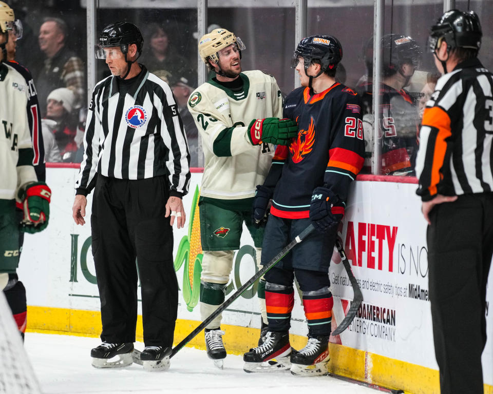 Iowa Wild forward Sammy Walker (25) reacts to a referee's call along side Coachella Valley Firebirds right wing Jesper Froden (28).