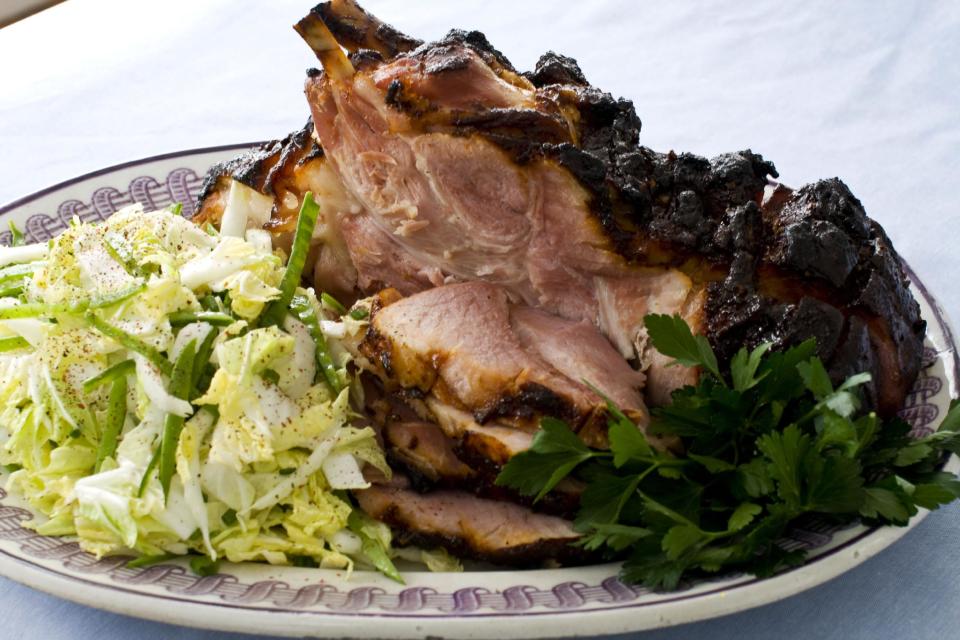 In this image taken on March 11, 2013, hoisin-glazed ham with Napa cabbage-snow pea slaw is shown served on a plate in Concord, N.H. (AP Photo/Matthew Mead)