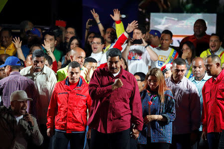 Venezuela's President Nicolas Maduro stands with supporters during a gathering after the results of the election were released, outside of the Miraflores Palace in Caracas, Venezuela, May 20, 2018. REUTERS/Carlos Garcia Rawlins