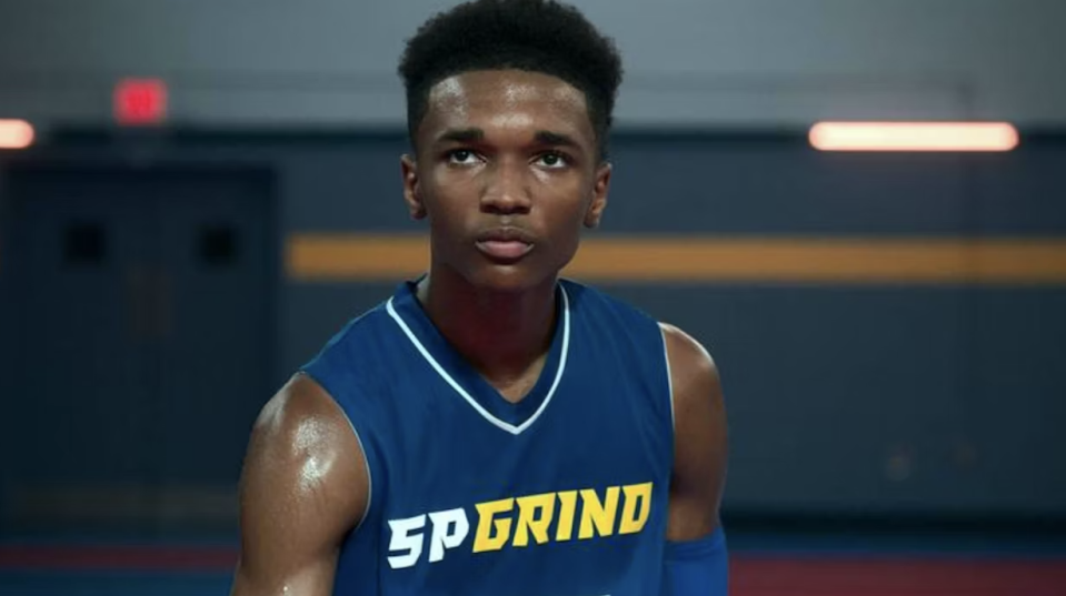 Close-up of a young man in a basketball jersey