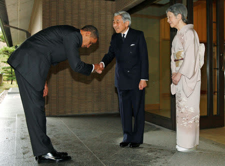 FILE PHOTO : U.S. President Barack Obama is greeted by Japanese Emperor Akihito and Empress Michiko upon arrival at the Imperial Palace in Tokyo November 14, 2009. REUTERS/Jim Young/File Photo