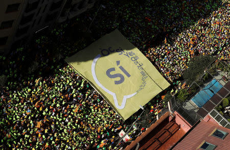 A giant "Yes" banner is carried through the streets as thousands of people gather for a rally on Catalonia's national day 'La Diada' in Barcelona, Spain, September 11, 2017. REUTERS/Albert Gea