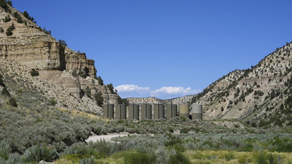 Oil sits in containers at a facility on public lands south of Duchesne, Utah on Thursday, July 13, 2023. Uinta Basin Railway, one of the United States’ biggest rail investment in more than a century, could be an 88-mile line in Utah that would run through tribal lands and national forest to move oil and gas to the national rail network. Critics question investing billions in oil and gas infrastructure as the country seeks to use less of the fossil fuels that worsen climate change. (AP Photo/Rick Bowmer)