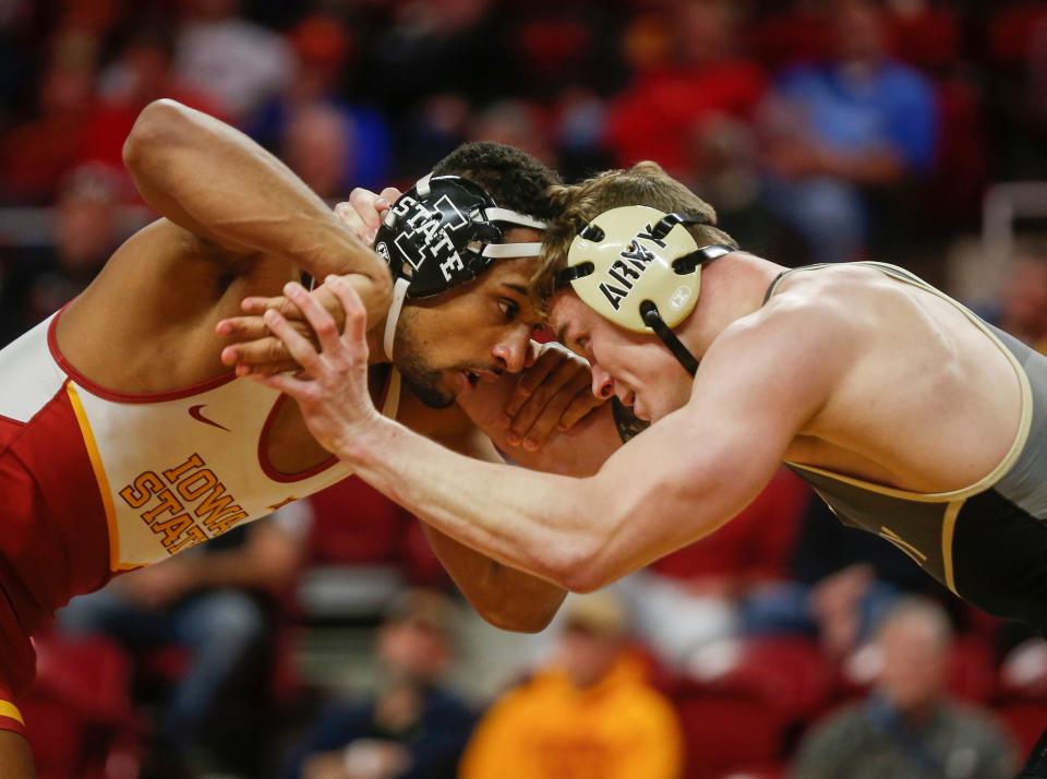 Iowa State senior Marcus Coleman, left, locks up with Army senior Brad Laughlin in their match at 184 pounds on Saturday, Nov. 27, 2021, at Hilton Coliseum in Ames.