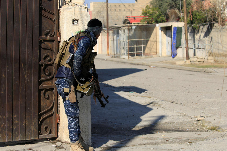 A member of Iraqi security forces take his position during a battle with Islamic State militants in Wahda district of eastern Mosul, Iraq, January 6, 2017.