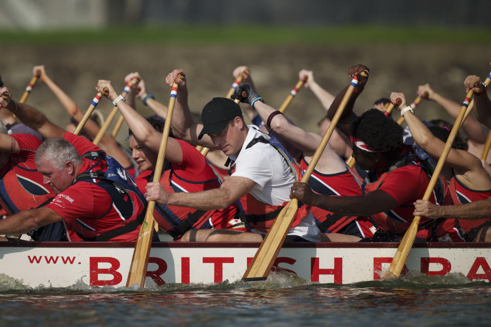 Britain's Prince William, center, participates in a dragon boat event in Singapore, Monday, Nov. 6, 2023. (AP Photo/Vincent Thian)