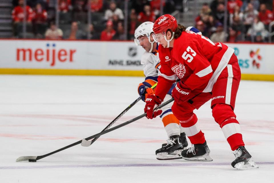 Detroit Red Wings defenseman Moritz Seider and New York Islanders right wing Cal Clutterbuck battle for the puck during the first period at Little Caesars Arena in Detroit on Thursday, Feb. 29, 2024.