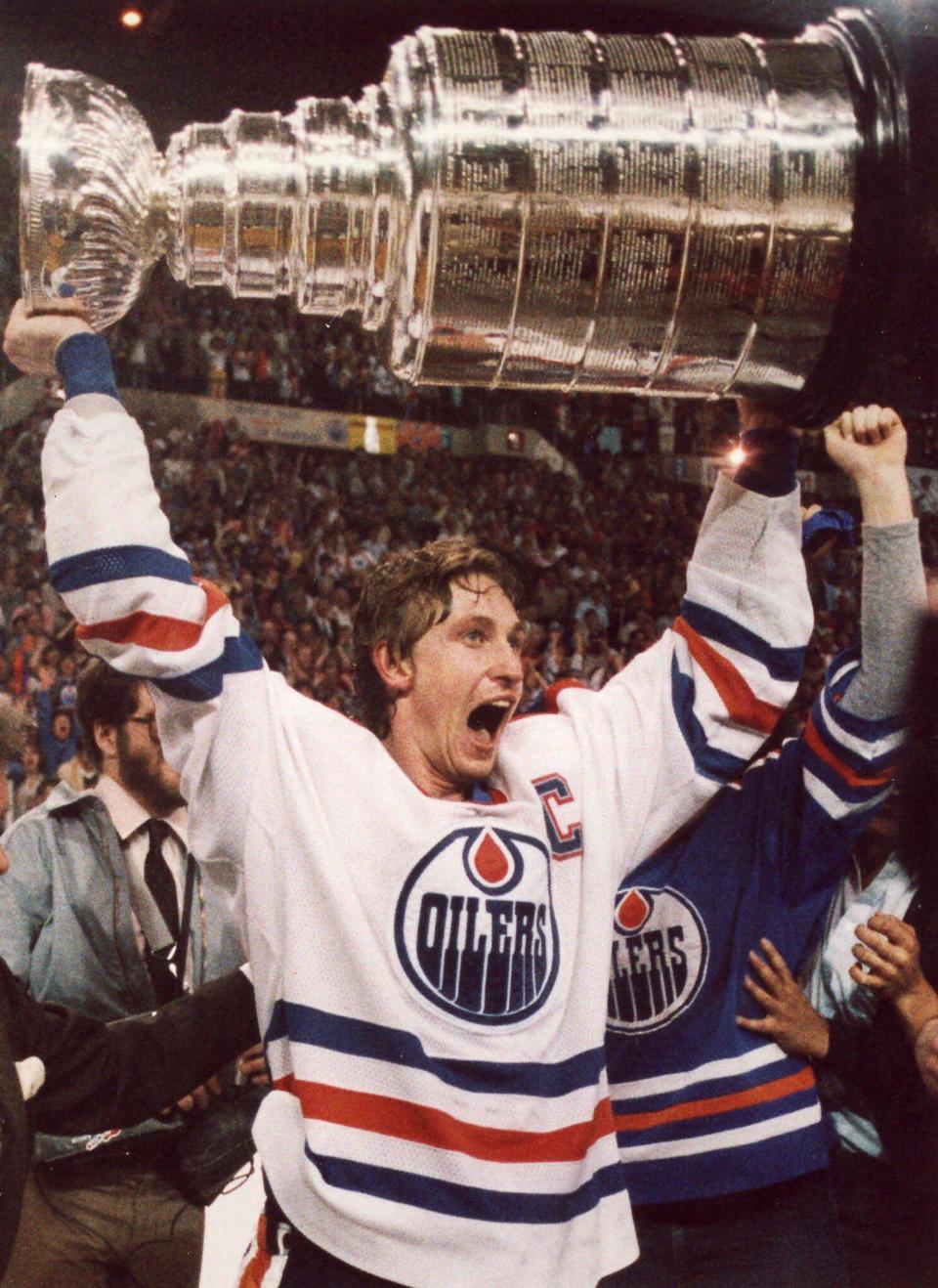 Edmonton Oilers hockey great Wayne Gretzky screams with joy as he hoists the Stanley Cup over his head following the team&apos;s win over the New York Islanders in Edmonton, in this May 19, 1984 photo.