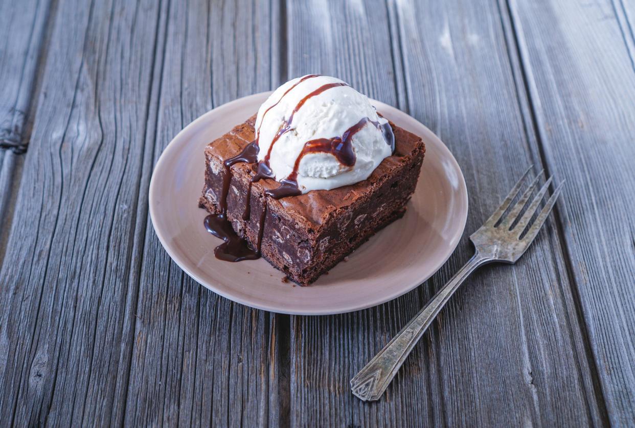 Chocolate Fudgy Brownie with Vanilla Ice Cream on top. Selective focus, toning.