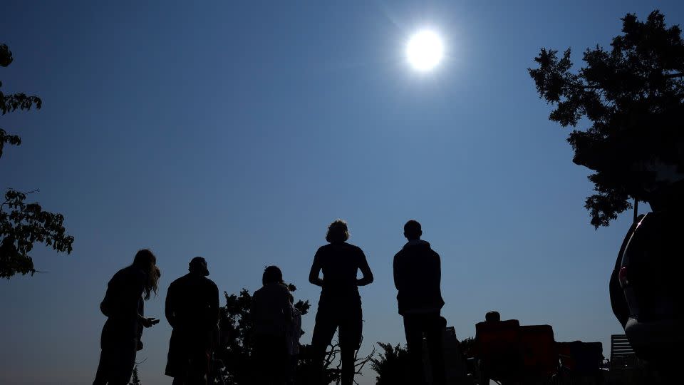 People gather near Redmond, Oregon, to view the sun as it nears a total eclipse by the moon in 2017. - Ted S. Warren/AP