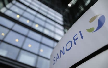 A logo is seen in front of the entrance at the headquarters French drugmaker Sanofi in Paris October 30, 2014. REUTERS/Christian Hartmann