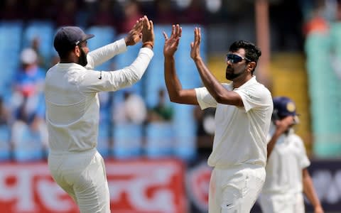 Ravichandran Ashwin (right) celebrates the wicket of Kraigg Brathwaite - Credit: ap