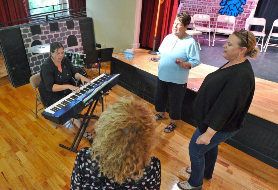 Music Director Sarah Troxler, of Plymouth, left, plays the keyboard as singers rehearse a song for the upcoming show at the Woodward School in Quincy. Clockwise from second left, Sheila Fahey, of Dorchester; Jennifer Fahey, of Dorchester; and Ann Kenneally-Ryan, of Quincy, Thursday, Sept. 15, 2022.