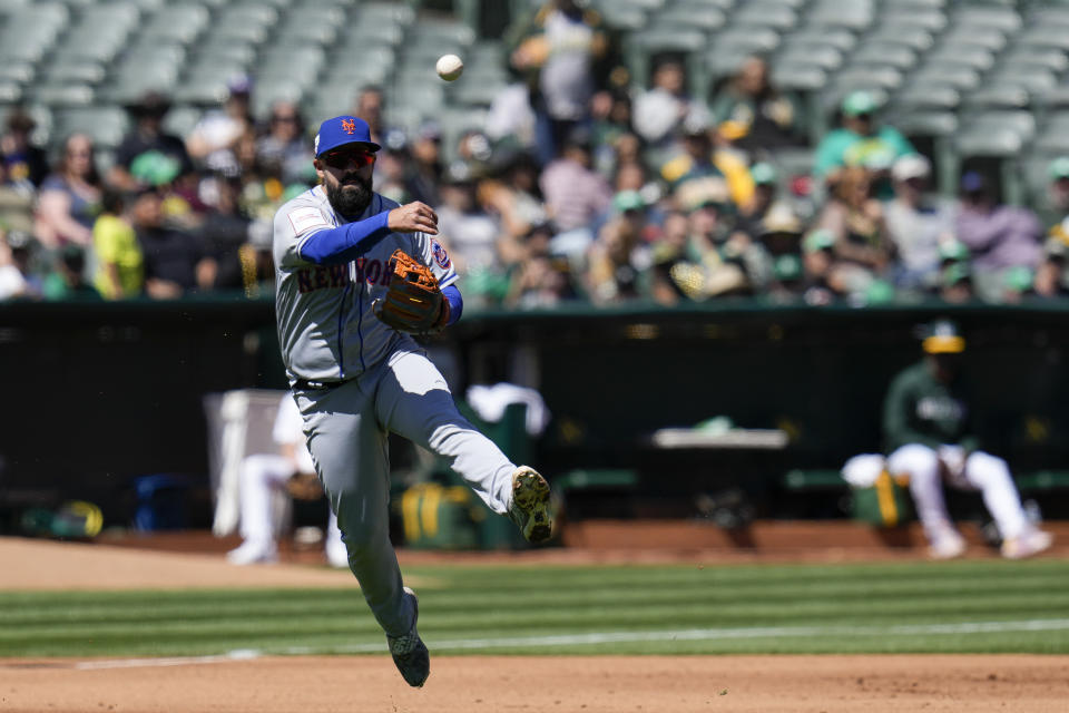 New York Mets third baseman Luis Guillorme throws to first for an out against Oakland Athletics' Aledmys Díaz during the fourth inning of a baseball game in Oakland, Calif., Saturday, April 15, 2023. (AP Photo/Godofredo A. Vásquez)