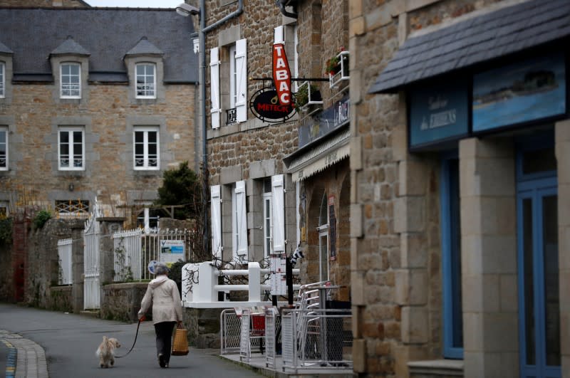 A woman walks in a street in Saint-Jacut-de-la-Mer in Brittany